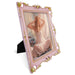 An ornate vintage-inspired picture frame with pink edges and gold accents, designed for an 8x10-inch picture, featuring a decorative painting of a woman inside.