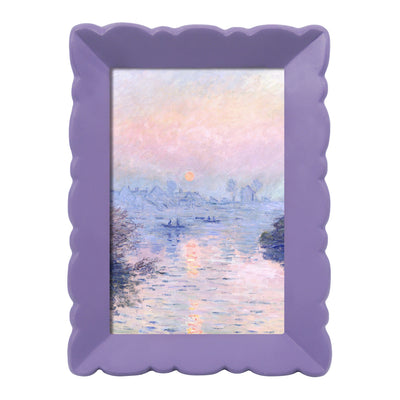 Purple scalloped frame with a painting of a sunset over water.