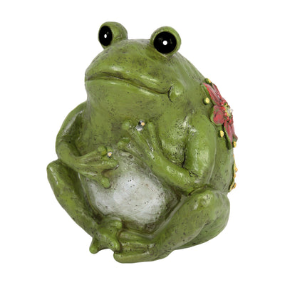 Decorative green frog figurine with a white pearl on a white background