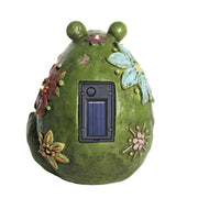 Decorative solar light shaped like a green frog with floral designs on a white background