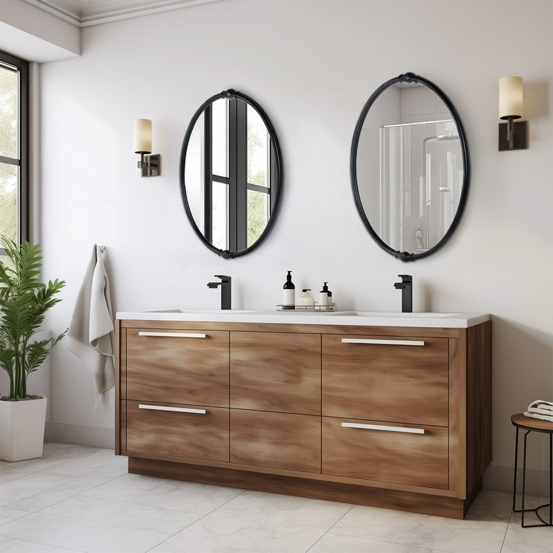 An oval-shaped mirror with a traditional frame in a bathroom setting, reflecting a modern shower stall and bathroom decor.