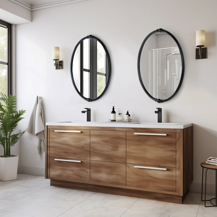 An oval-shaped mirror with a traditional frame in a bathroom setting, reflecting a modern shower stall and bathroom decor.