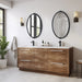An oval-shaped mirror with a traditional frame in a bathroom setting, reflecting a modern shower stall and bathroom decor.