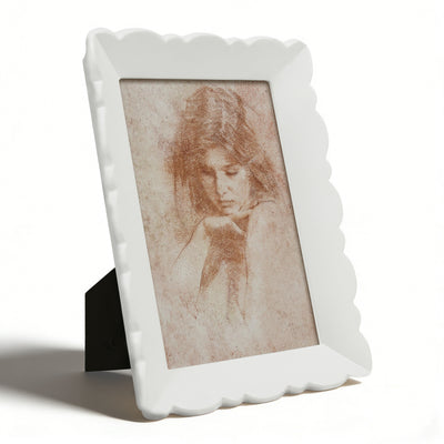 White decorative photo frame with a vintage-style portrait inside on a white background