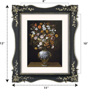 Decorative black picture frame with floral design, containing a painting of flowers in a vase.