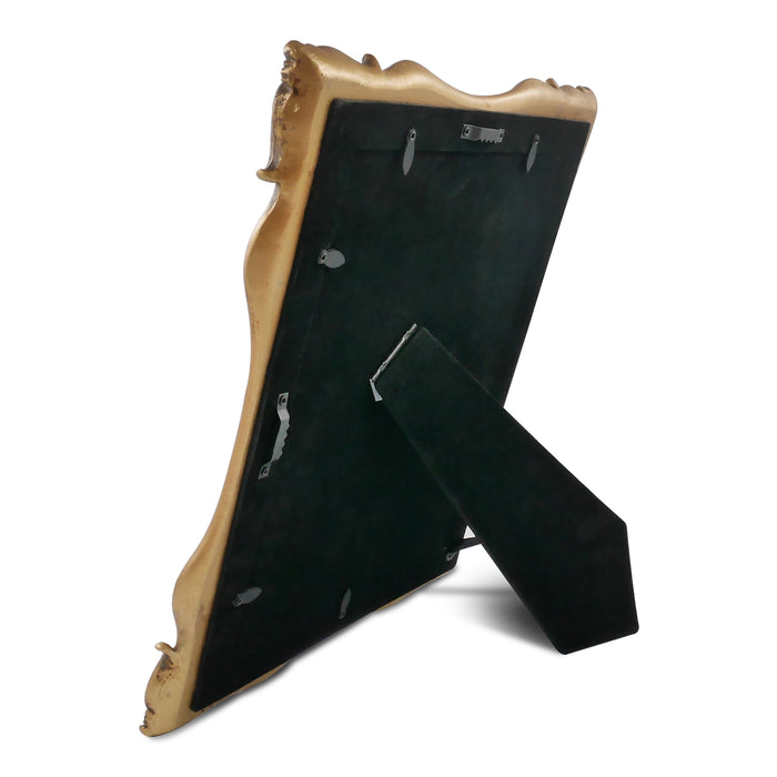 Decorative gold frame with a black mat on a white background.