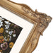 Decorative gold frame with floral design on a white background.