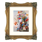 Gold picture frames featuring vintage-inspired floral carvings at each corner.