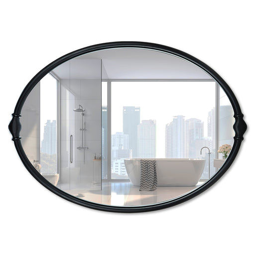 An oval-shaped mirror with a traditional frame in a bathroom setting, reflecting a modern shower stall and bathroom decor.