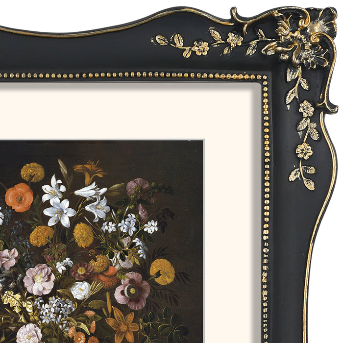 Decorative black and gold frame with floral design, containing a painting of flowers.