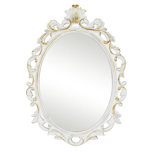 An oval mirror with a scroll design in an white with gold finish, reflecting a well-lit interior room.
