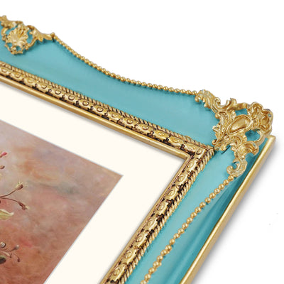 Blue 8x10 antique picture frame with hand-carved flower embossed border displayed in home décor setting
