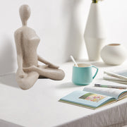 This yoga sculpture has a neat stone-looking with beige color and smooth texture. It can fit any home office decor style. 