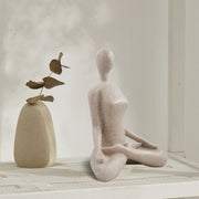 This yoga sculpture has a neat stone-looking with beige color and smooth texture. It can fit any home office decor style. 