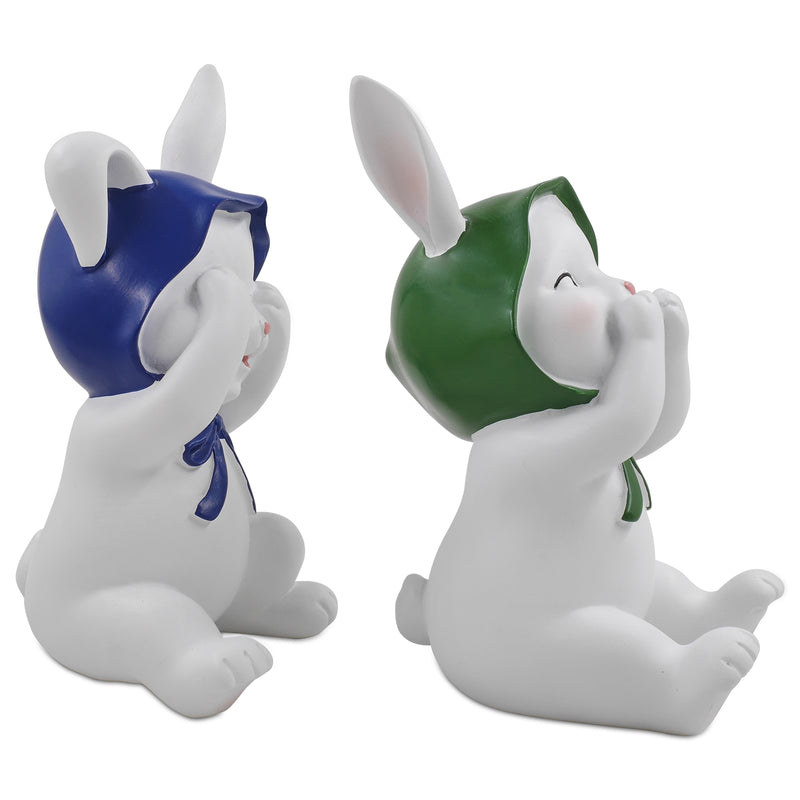 Two resin figurines of sitting rabbits with hats, one with eyes covered and one with a mouth covered, in different poses.
