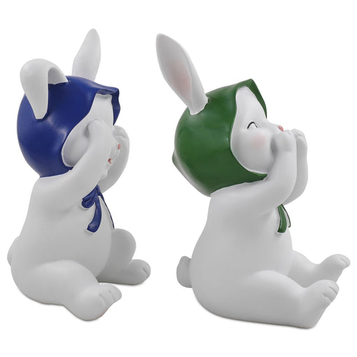 Two resin figurines of sitting rabbits with hats, one with eyes covered and one with a mouth covered, in different poses.