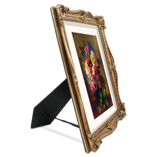 Gold 8x10 antique picture frame with ornate baroque floral resin border, angled view showing easel back stand