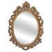 A vintage oval wall mirror with a decorative gold frame, designed for mounting on a wall.