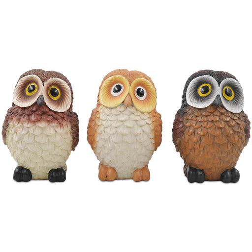 A set of three resin owl figurines, painted in different colors, displayed side by side.