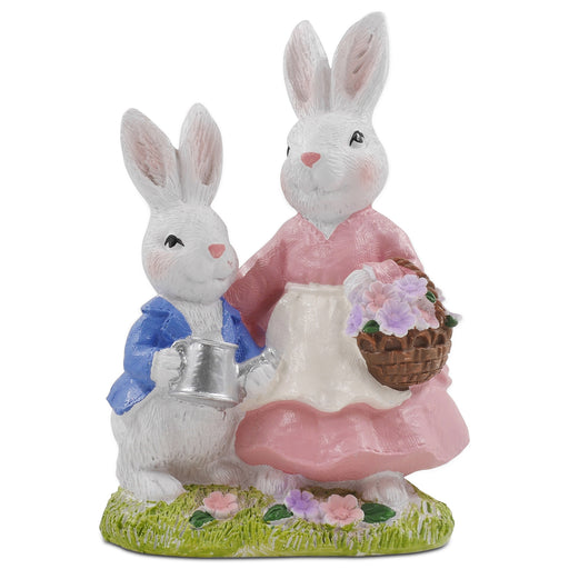 A hand-painted resin figurine of a rabbit family, comprising a mother and child, dressed in decorative outfits and holding a floral basket and a metal pot.