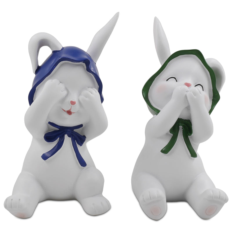 Two resin figurines of sitting rabbits with hats, one with eyes covered and one with a mouth covered, in different poses.