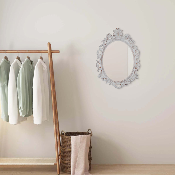 A vintage oval wall mirror with a decorative white frame, designed for mounting on a wall.