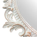 A vintage oval wall mirror with a decorative white frame, designed for mounting on a wall.
